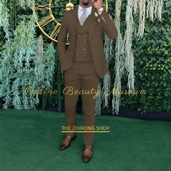 A man wears a brown three-piece suit consisting of a single-breasted jacket, a double-breasted vest, and matching trousers.