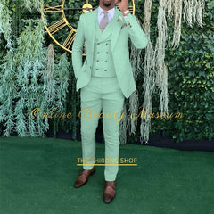 A man wears a mint green three-piece suit consisting of a single-breasted jacket, a double-breasted vest, and matching trousers.