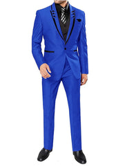 A man wears a royal blue three-piece suit with black lapel trim, a black vest, and a patterned tie.
