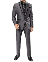 A man wears a grey three-piece suit with black lapel trim, a black shirt, and a patterned tie.