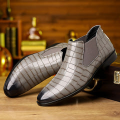 A pair of grey slip-on ankle boots featuring a plaid pattern and a durable rubber sole.