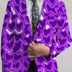 A man wears a purple blazer featuring a repeating heart pattern over a white shirt and grey tie.