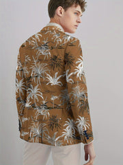 A man wears a brown blazer featuring a white coconut tree print with a button closure.