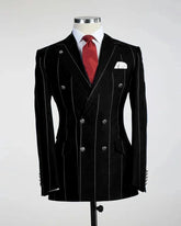 A black double-breasted blazer with white pinstripes, a red tie, and a white pocket square.