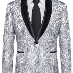 A men's slim-fit paisley patterned suit jacket with a black shawl lapel and a matching tie.