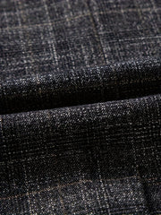 Close-up of a dark grey blazer fabric featuring a subtle plaid pattern and textured weave.