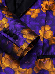 A purple and orange floral print blazer featuring a black shawl lapel and buttoned cuffs.