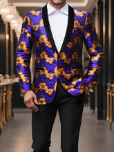 A man wears a purple and orange floral print blazer with a black shawl lapel and one button.