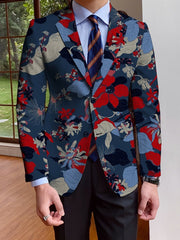 A man wears a single-breasted navy blue blazer featuring a vibrant red and light blue floral print.