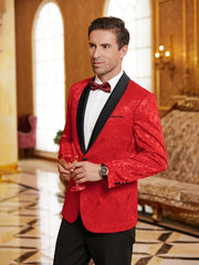 A man wears a red paisley floral tuxedo jacket with a black shawl lapel and a matching bow tie.