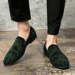 Men's green rhinestone-embellished slip-on loafers with a pointed toe and black trim.