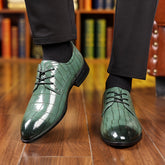 Men's glossy green crocodile-pattern lace-up dress shoes.