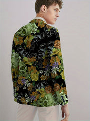 A man wears a black blazer featuring a green skull and floral print with button details.