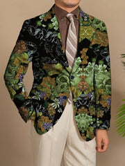 A man wears a black blazer featuring a green gothic skull and floral print with button details.