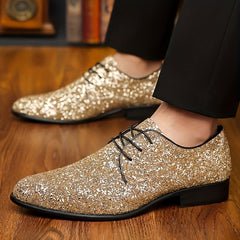 A pair of men's gold glitter lace-up dress shoes with a pointed toe and black sole.