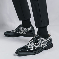 Men's pointed-toe oxford dress shoes featuring a leopard print pattern and black patent accents.