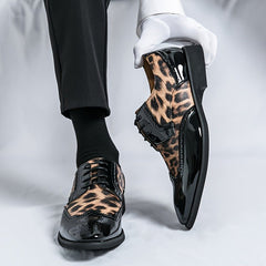 Men's leopard print pointed-toe oxford dress shoes with black patent leather accents and laces.