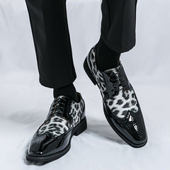 Men's pointed-toe oxford dress shoes featuring a black patent finish and leopard print panels.