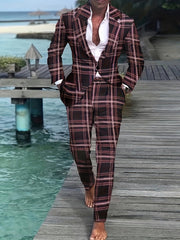 A man wears a brown and white plaid skinny fit suit with a lapel collar and pockets.