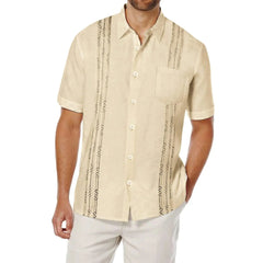 A beige short-sleeve button-down shirt with vertical geometric embroidery and a chest pocket.