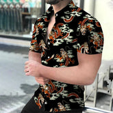 A man wears a black short-sleeved button-down shirt featuring an orange dragon and cloud print.