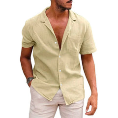 A man wears a beige short-sleeve button-down shirt with a point collar and a straight fit.