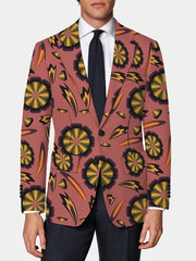 A men's skinny fit suit jacket in a dusty rose color featuring a bold, retro floral print.