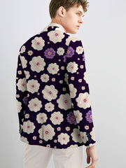 A man wears a skinny fit navy blue suit jacket featuring a white and purple floral pattern.