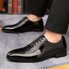 Men's black lace-up dress shoes featuring a pointed toe and a crocodile-textured upper.