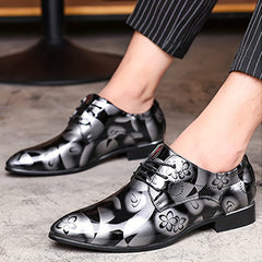 Men's black and silver floral print pointed-toe dress shoes with a lace-up closure.