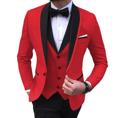 A man wears a red slim-fit tuxedo jacket with a black shawl lapel, matching vest, and bowtie.