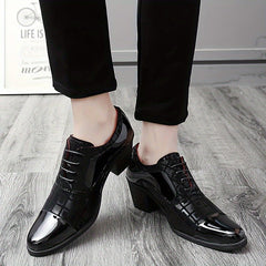 A pair of black lace-up dress shoes with a block heel and a mix of patent and textured leather.