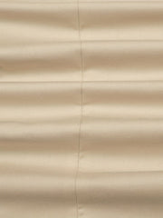 Close-up of a beige blazer made from woven polyester fabric with a visible vertical seam.