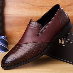 A brown slip-on dress shoe with a pointed toe and a mix of smooth and crocodile-embossed textures.