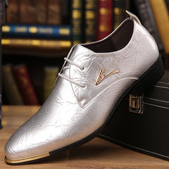 A silver metallic lace-up dress shoe with a textured finish and gold-tone hardware.
