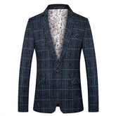 A single-breasted men's blazer in a dark blue plaid pattern with a patterned interior lining.