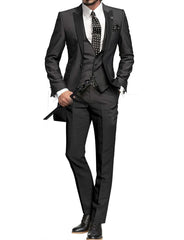A man wears a charcoal grey three-piece suit with a peak lapel jacket, vest, and slim-fit trousers.