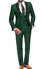 A man wears a dark green three-piece suit with a black peak lapel, white shirt, and polka dot tie.