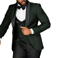 A man wears a dark green slim-fit three-piece tuxedo with a black shawl lapel and a bow tie.