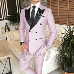 A light pink double-breasted men's suit with black peak lapels and a black tie.