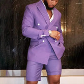 A man wears a lavender double-breasted suit jacket with matching tailored shorts.
