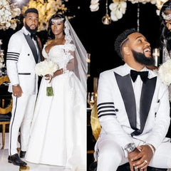 A man wears a white slim-fit tuxedo with black lapels and striped sleeve details.