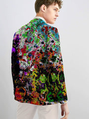 A man wears a skinny fit suit jacket featuring a vibrant, multicolored abstract print.