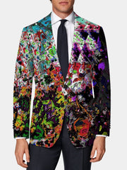 A man wears a skinny fit suit jacket featuring a vibrant, multicolored abstract paint print.