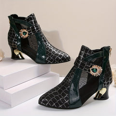A pair of black mesh ankle boots with a pointed toe, block heel, and decorative green gem accents.
