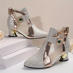 A pair of silver mesh pointed-toe block heel sandals with gold snakeskin-textured accents.