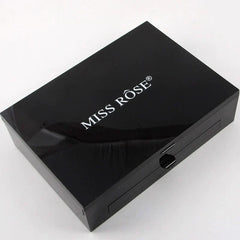 A closed black rectangular makeup palette with the Miss Rose logo printed on the lid.