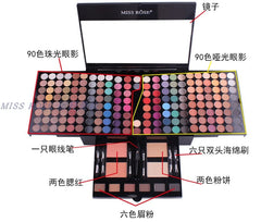 A Miss Rose piano-style makeup palette featuring eyeshadows, blush, powder, brow powder, and applicators.