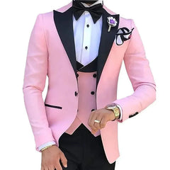 A slim-fit three-piece men's suit featuring a pink blazer with black lapels and a black vest.