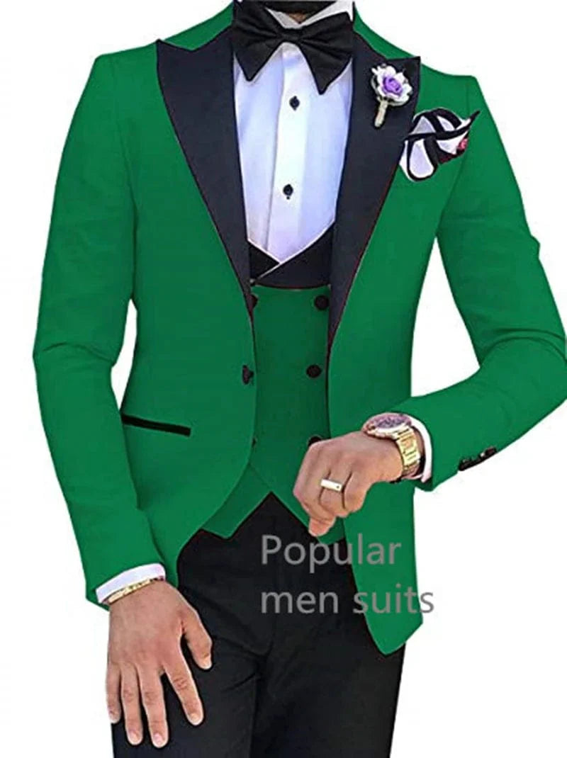 A man wears a slim-fit green three-piece suit with a black peak lapel, vest, and bow tie.